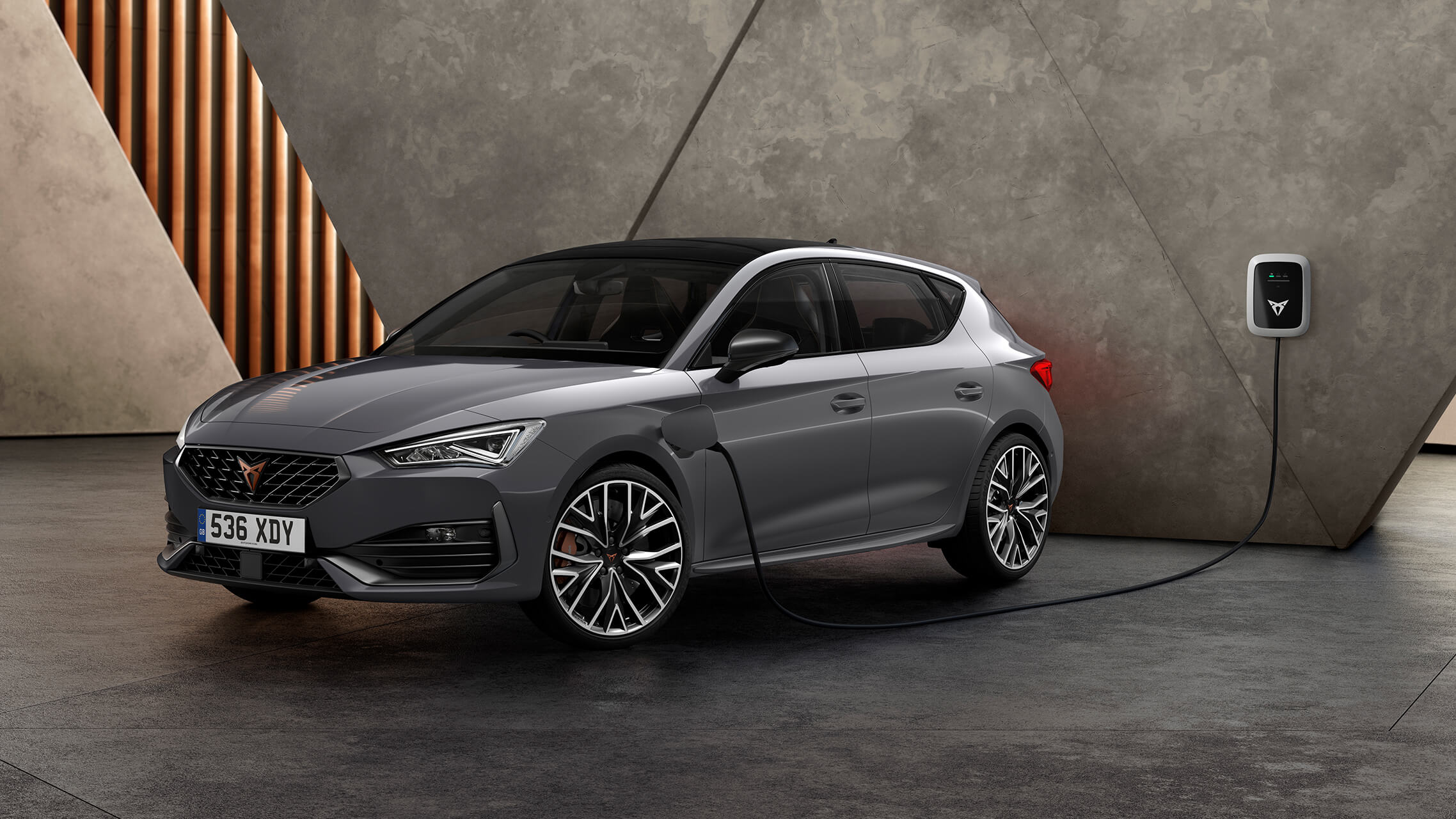 new CUPRA Leon ehybrid five door magnetic tech matte compact sports car side view charging