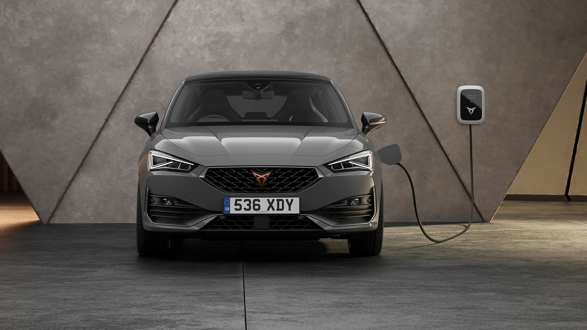 new CUPRA Leon ehybrid five door magnetic tech matte compact sports car rear side view charging