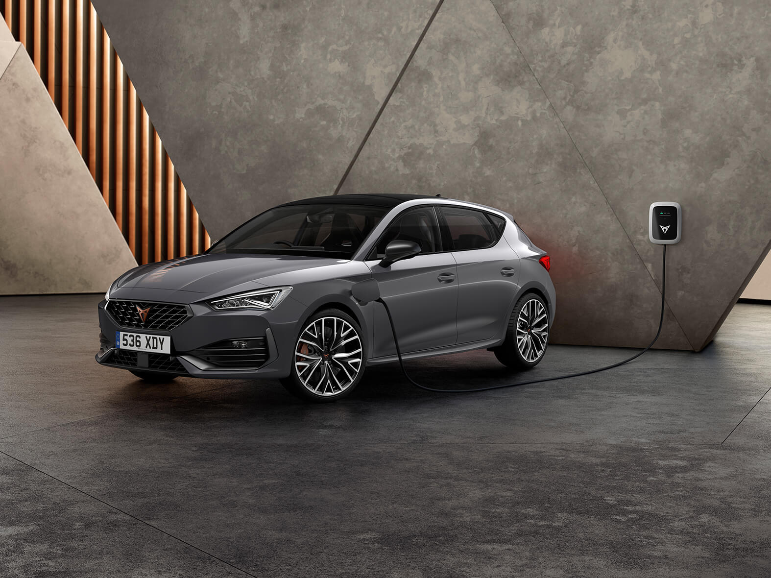 new CUPRA Leon ehybrid five door magnetic tech matte compact sports car front side view charging